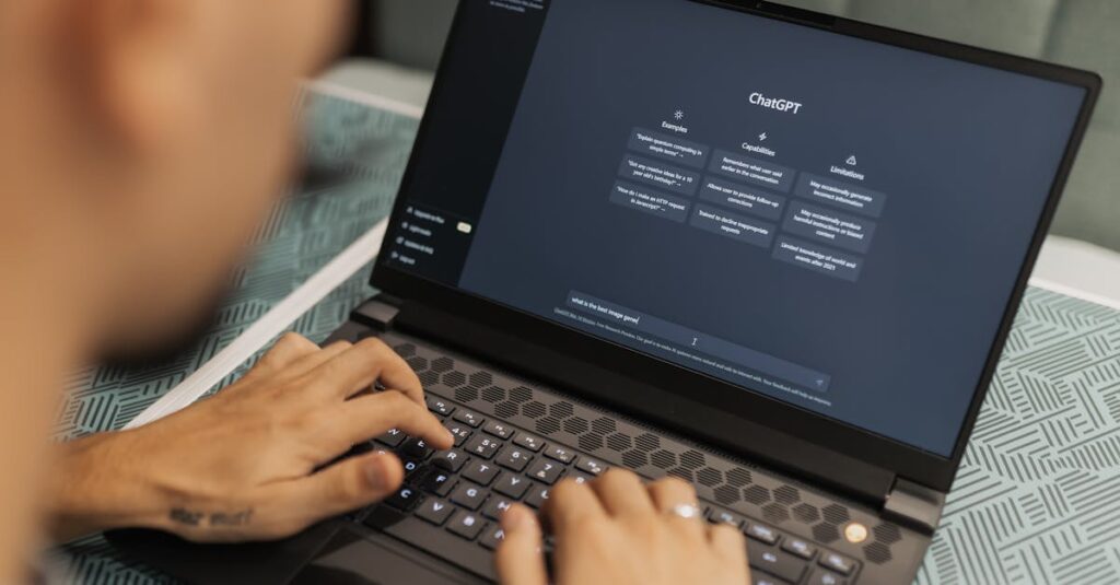 Close-up of a person typing on a laptop displaying the ChatGPT interface, emphasizing modern technology use.
