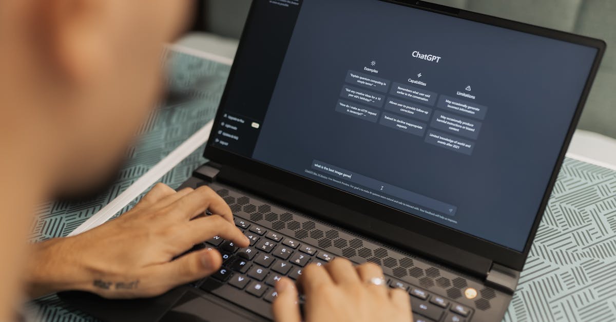 Close-up of a person typing on a laptop displaying the ChatGPT interface, emphasizing modern technology use.